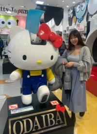 Italian tutor Darlene Chen standing near a hello kitty statue inside a store