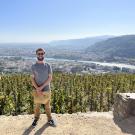 Cole Bacon stands overlooking a town in France.