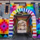 A passage through a building with colorful patterns painted on it.