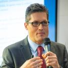 Man with hand-held microphone giving a lecture